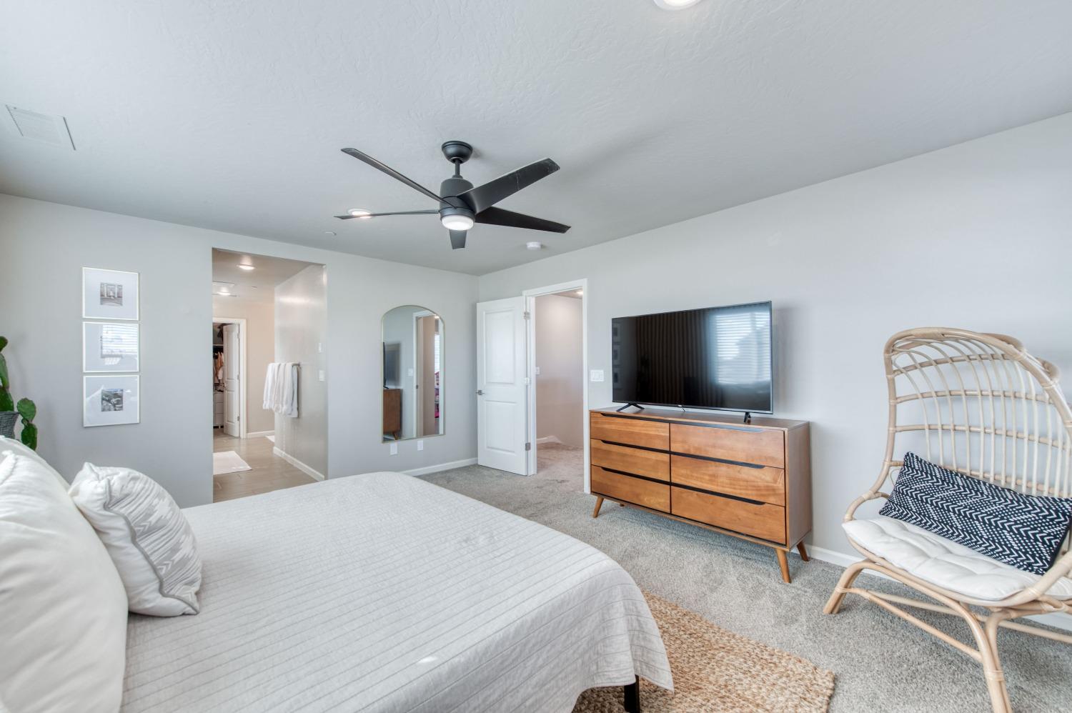 4136 Mecca Avenue Clovis, CA 93619 - Photo 27 of 44 a bedroom with a bed and a flat screen tv