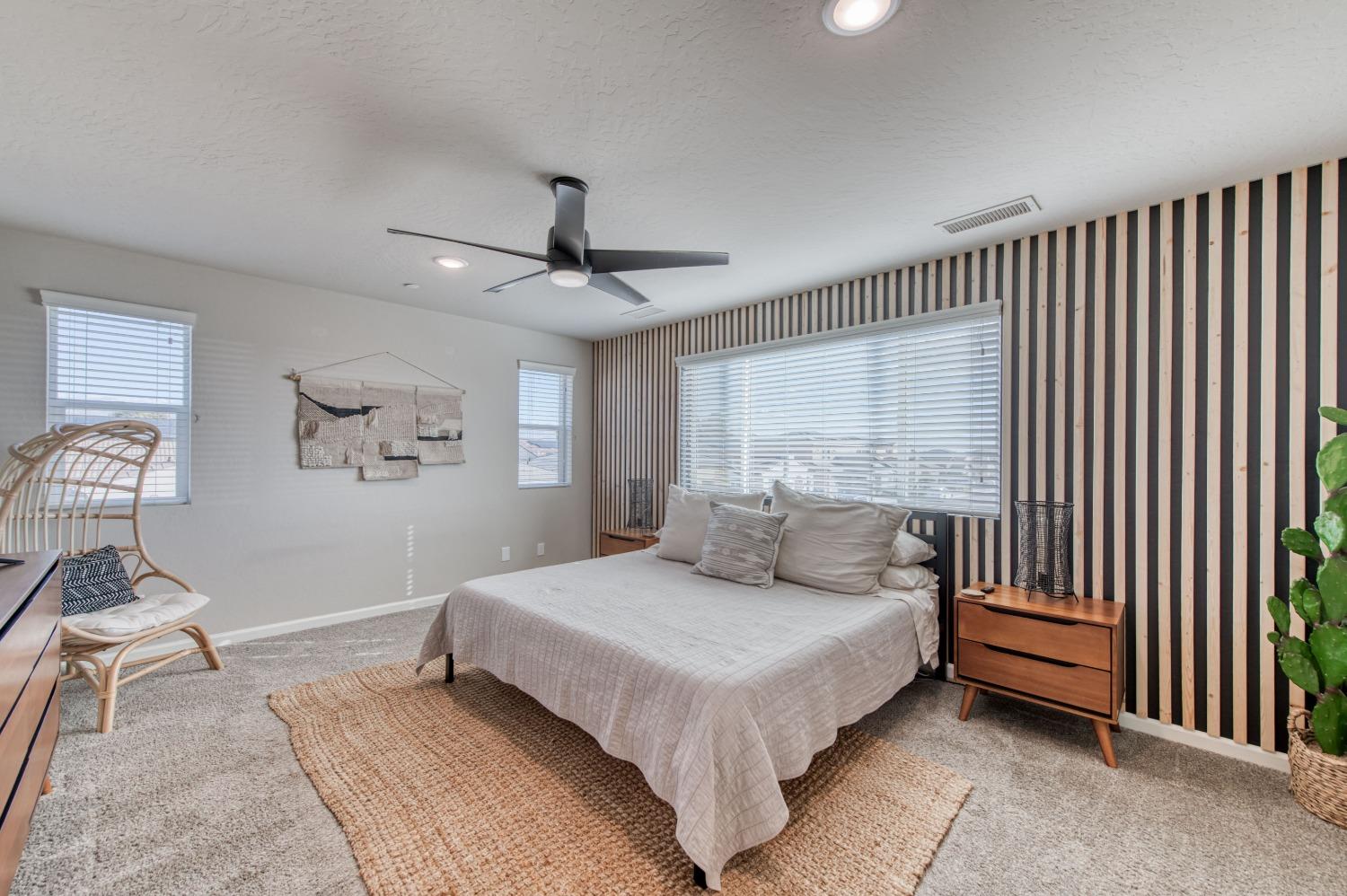 4136 Mecca Avenue Clovis, CA 93619 - Photo 29 of 44 a bedroom with a bed and a chandelier