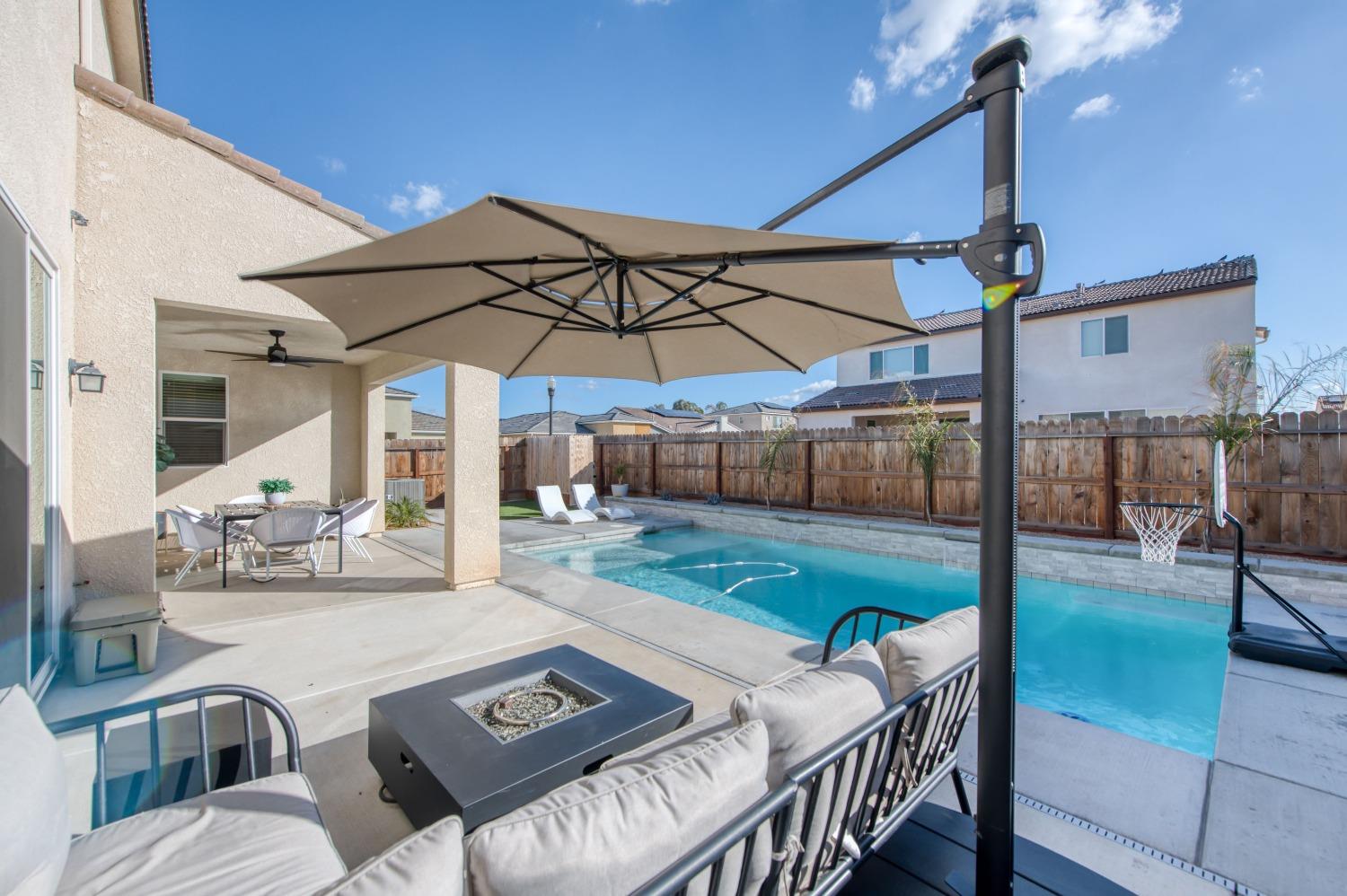 4136 Mecca Avenue Clovis, CA 93619 - Photo 3 of 44 a view of a patio with a table chairs and a backyard