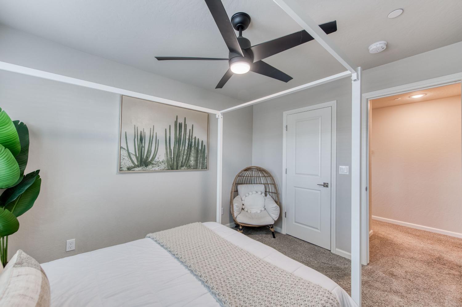 4136 Mecca Avenue Clovis, CA 93619 - Photo 37 of 44 a bedroom with a bed and a painting on the wall