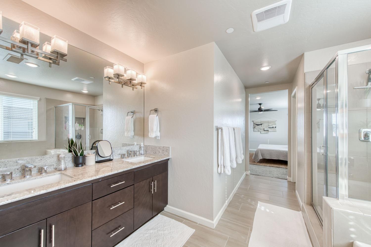 4136 Mecca Avenue Clovis, CA 93619 - Photo 5 of 44 a spacious bathroom with a double vanity sink mirror and shower