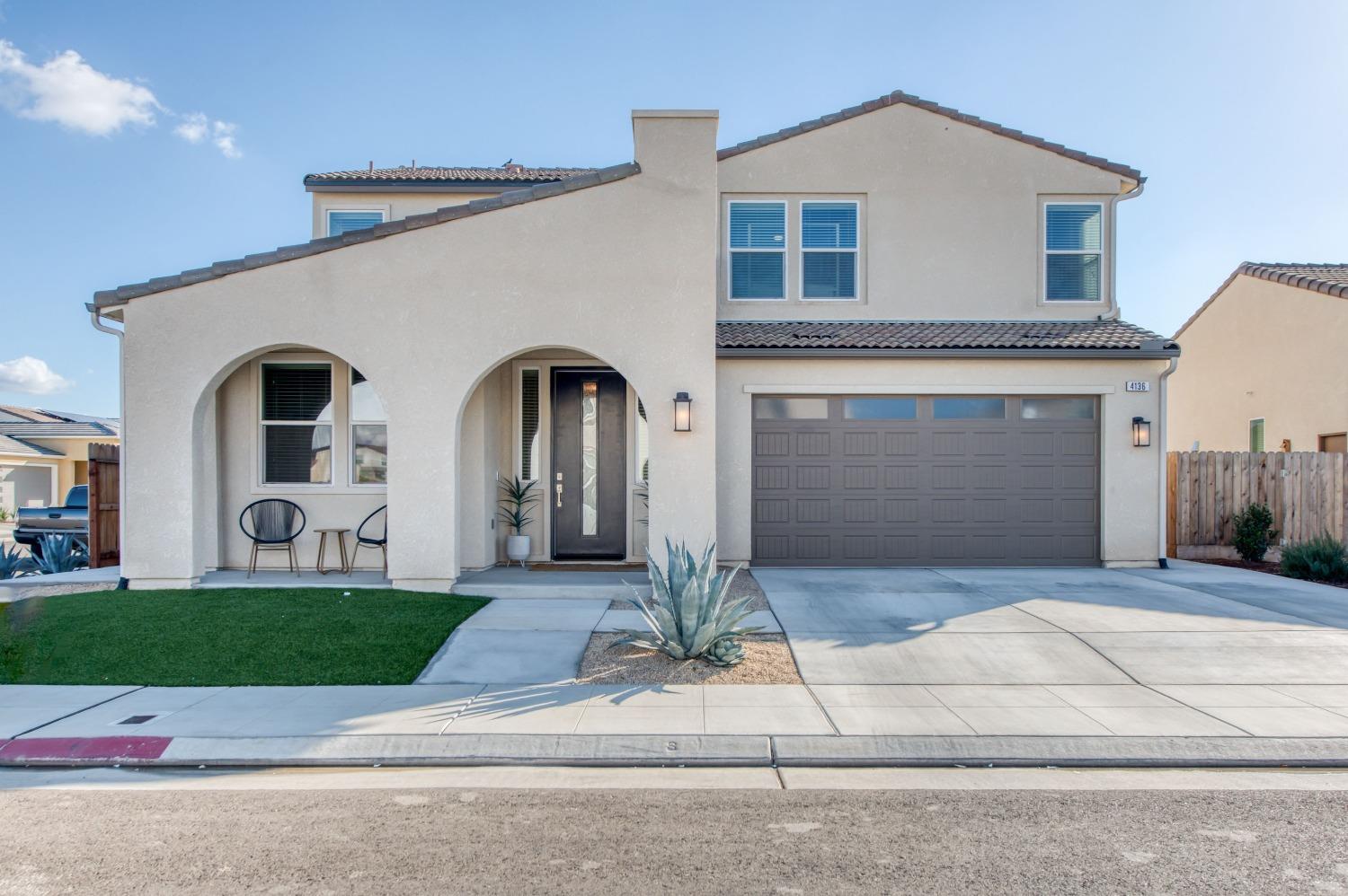 4136 Mecca Avenue Clovis, CA 93619 - Photo 6 of 44 a front view of a house with a yard and garage