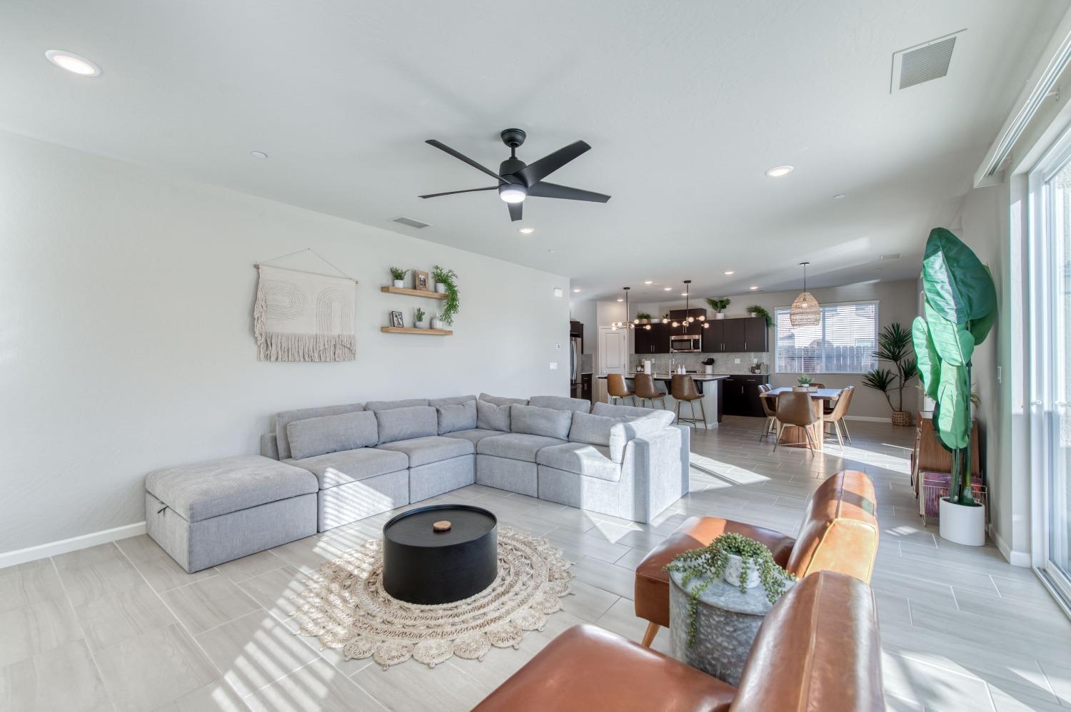 4136 Mecca Avenue Clovis, CA 93619 - Photo 10 of 44 a living room with furniture and a view of kitchen