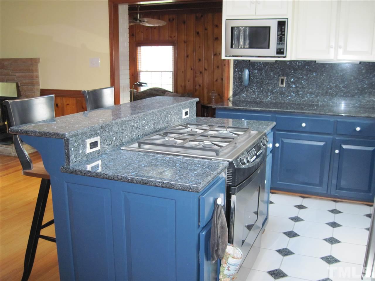 4105 St James Church Road Raleigh, NC 27604 - Photo 11 of 24 a kitchen with a stove and a microwave