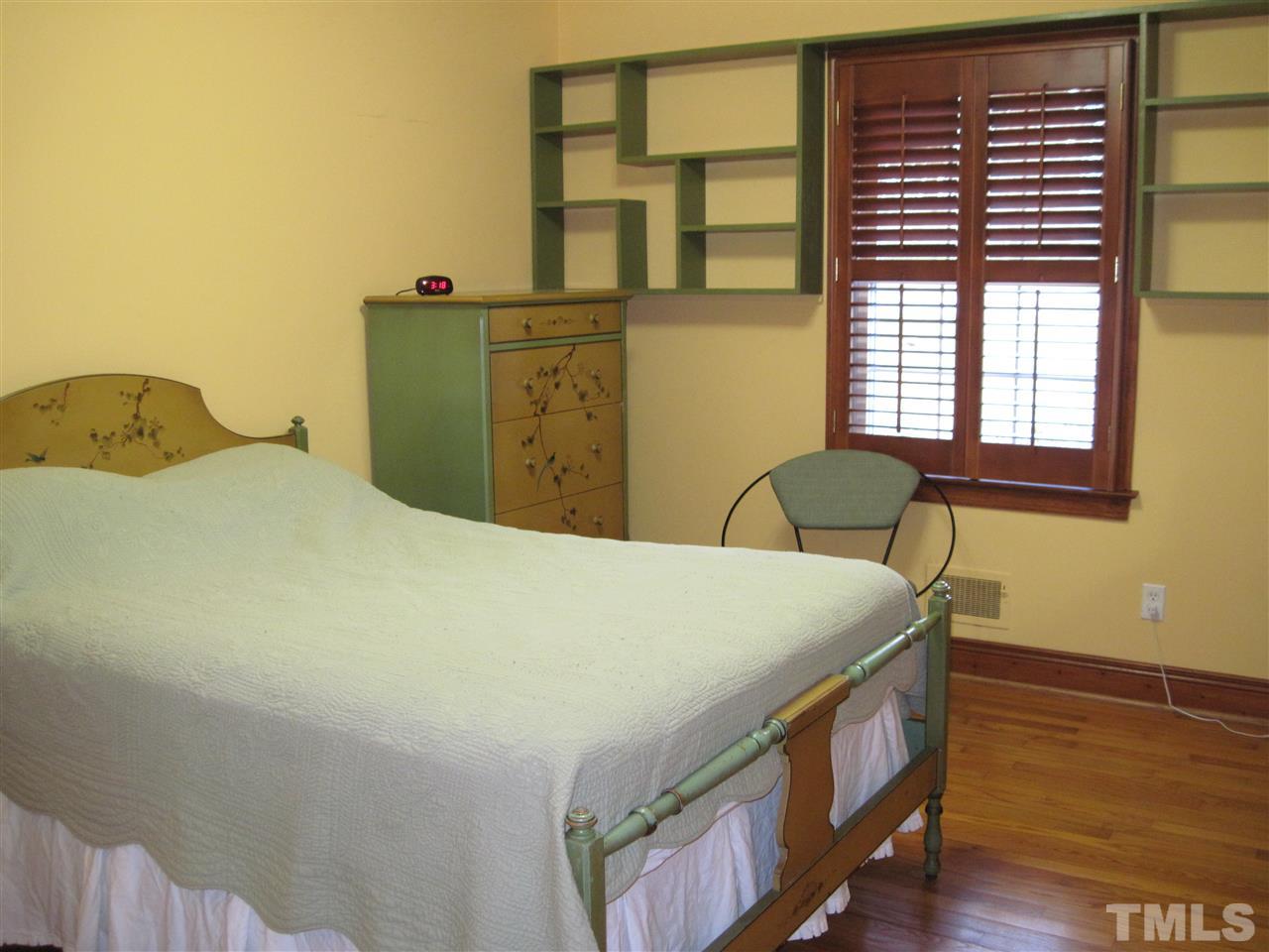 4105 St James Church Road Raleigh, NC 27604 - Photo 12 of 24 a bed sitting in a bedroom next to a window