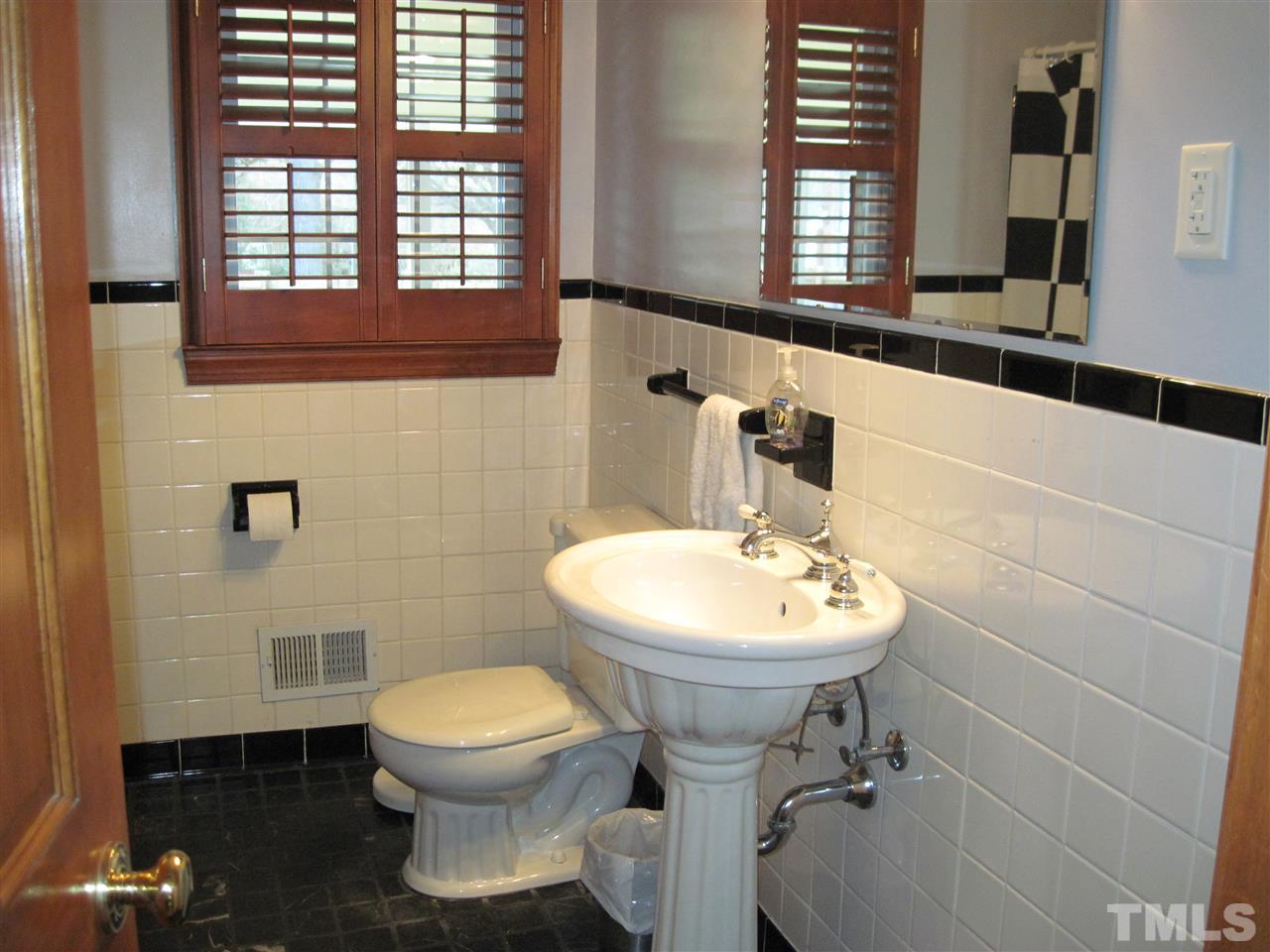 4105 St James Church Road Raleigh, NC 27604 - Photo 13 of 24 a bathroom with a sink toilet and a mirror