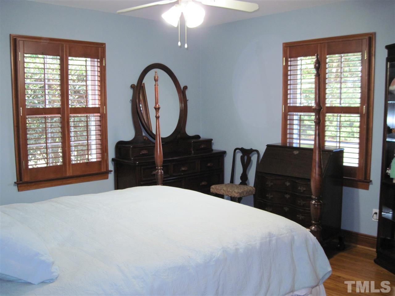 4105 St James Church Road Raleigh, NC 27604 - Photo 14 of 24 a large bed sitting in a bedroom next to a window