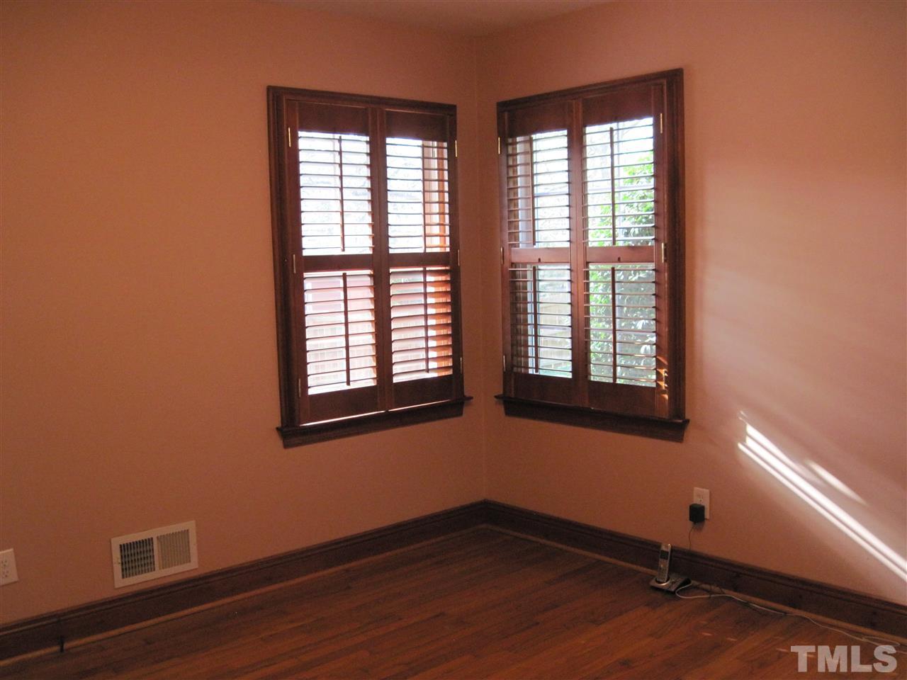 4105 St James Church Road Raleigh, NC 27604 - Photo 15 of 24 a view of an empty room with wooden floor and a window