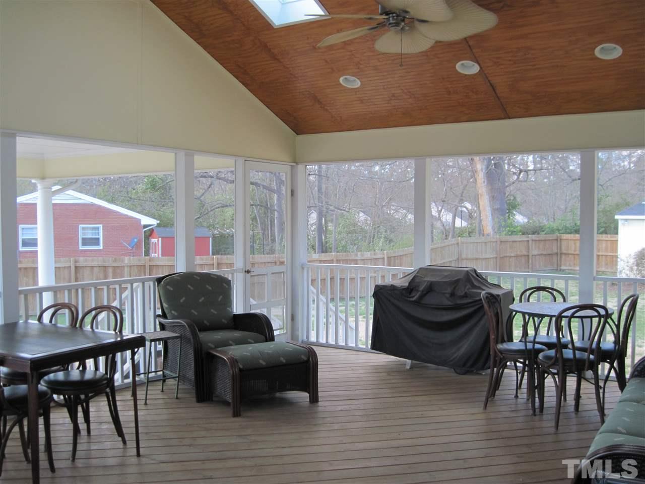 4105 St James Church Road Raleigh, NC 27604 - Photo 16 of 24 a living room with furniture and a floor to ceiling window