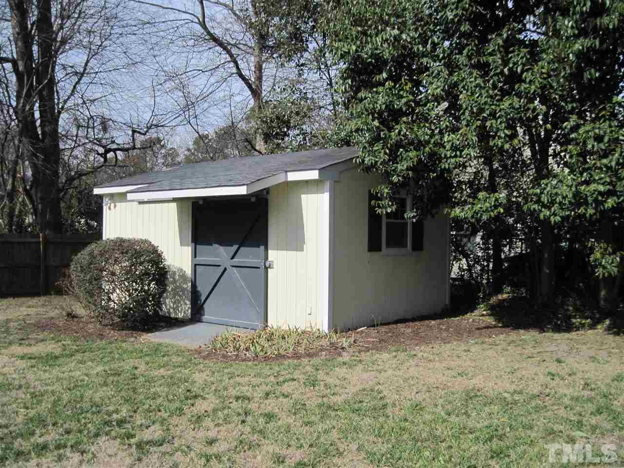 4105 St James Church Road Raleigh, NC 27604 - Photo 20 of 24 a view of a house with a yard and garage