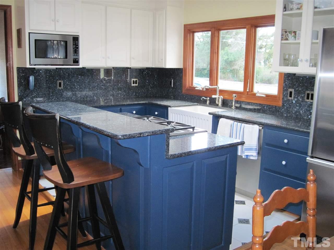 4105 St James Church Road Raleigh, NC 27604 - Photo 8 of 24 a kitchen with a sink a window and chairs