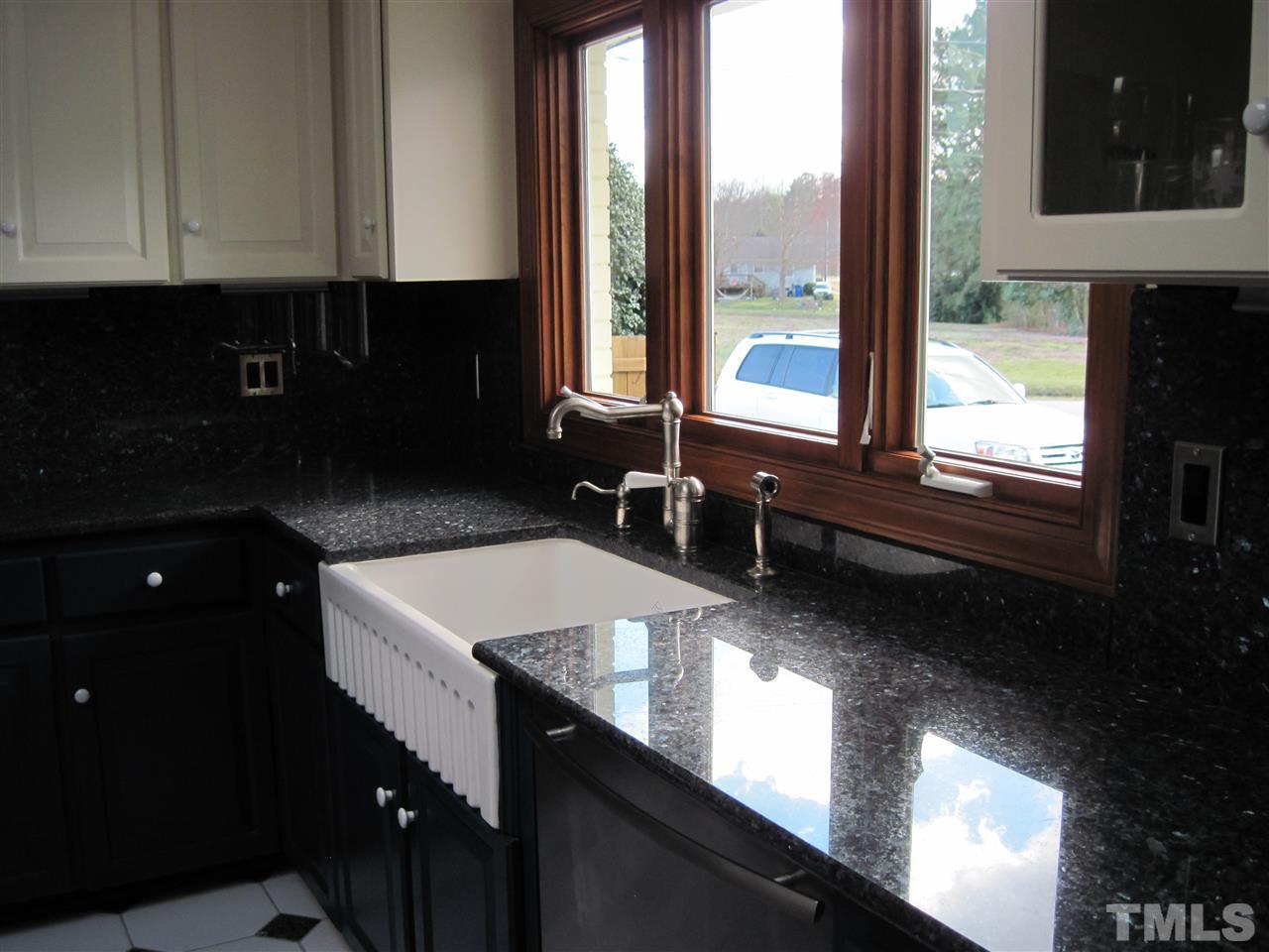 4105 St James Church Road Raleigh, NC 27604 - Photo 9 of 24 a kitchen with a sink a counter top space and a window