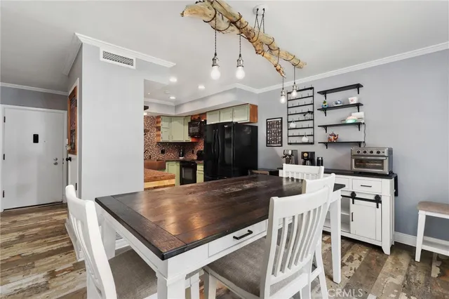 a kitchen with a stove a refrigerator and a dining table