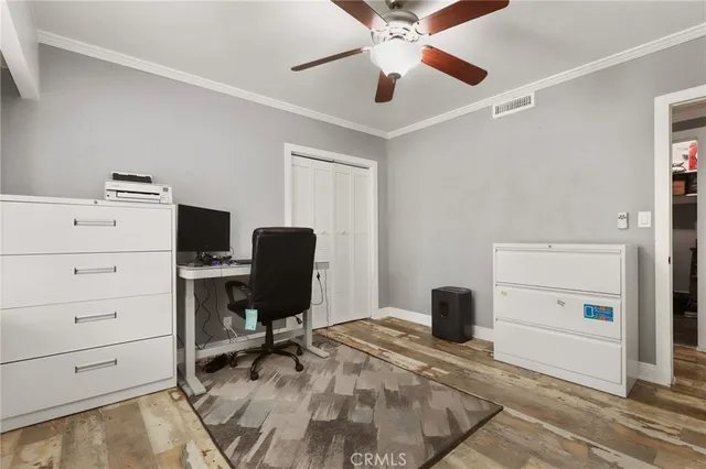 a view of a workspace with furniture and a window