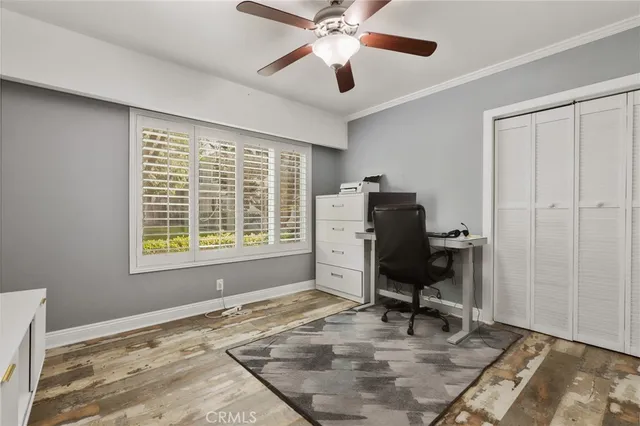 a bedroom with a baby bed and dresser
