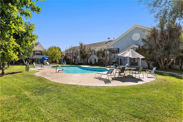 a view of a backyard with swimming pool
