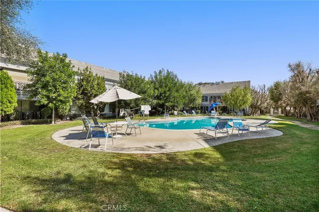 a view of a swimming pool with a yard