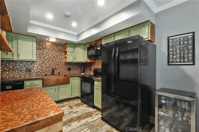 a kitchen with stainless steel appliances granite countertop a refrigerator and a stove top oven