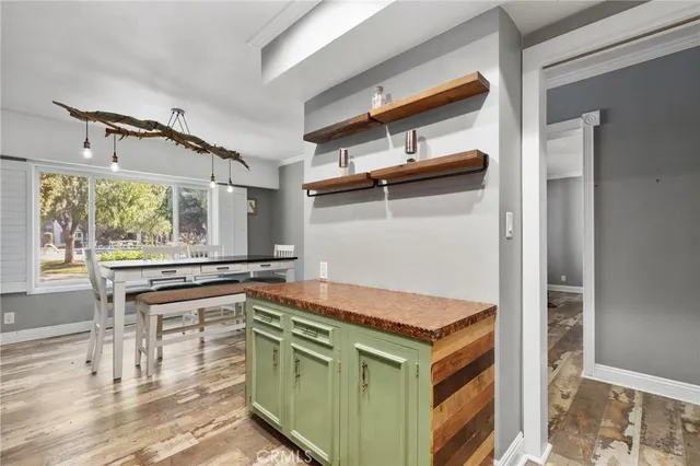 a kitchen with a stove and a wooden floor