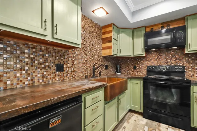 a kitchen with stainless steel appliances wooden cabinets and a stove top oven