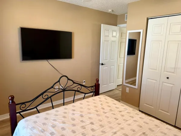 a bathroom with a granite countertop toilet sink and mirror
