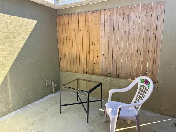 a view of balcony with wooden floor and a potted plant