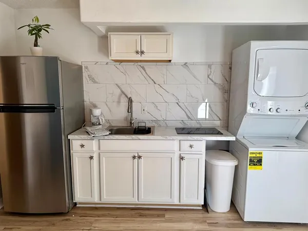 a kitchen with a refrigerator and a stove