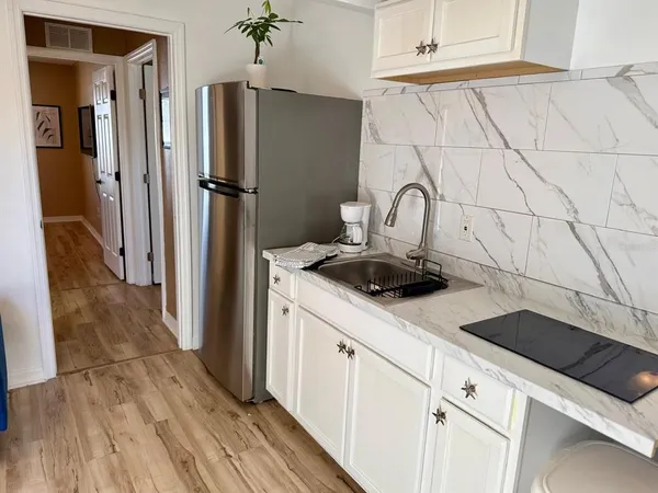 a kitchen with a refrigerator and a sink