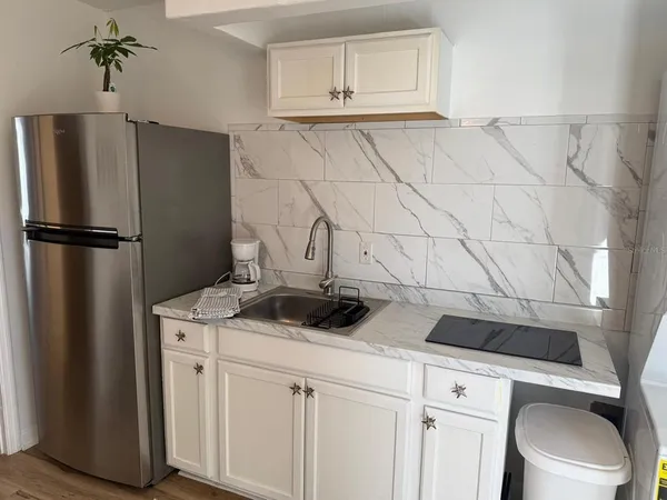 a kitchen with a refrigerator and cabinets