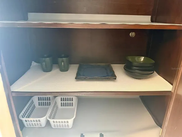 a view of a kitchen with cabinets and wooden floor