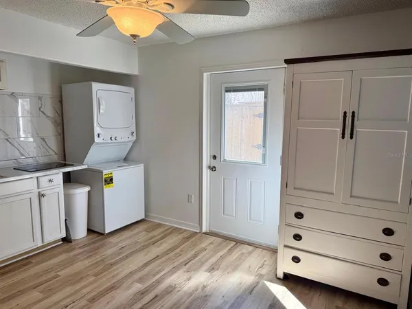 a view of a hallway with wooden floor and closet area