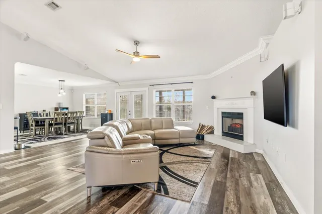 a living room with furniture fireplace and flat screen tv