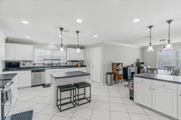 a kitchen with a sink counter top space appliances and cabinets