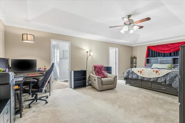 a bedroom with a bed and a chandelier