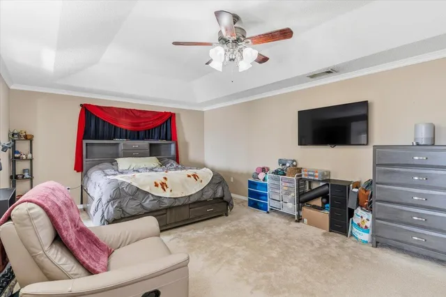 a bedroom with furniture and a flat screen tv