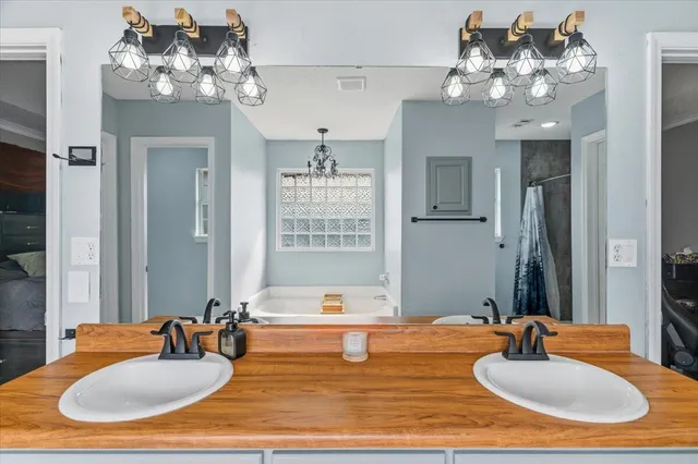 a bathroom with a sink double vanity granite and a mirror