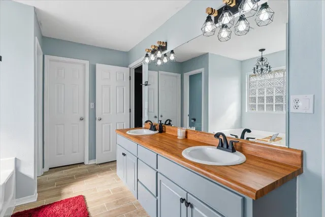 a bathroom with a sink double vanity and a mirror