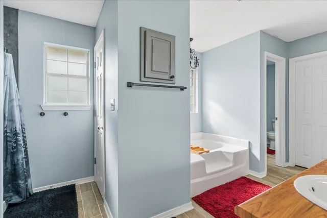 a bathroom with a tub and shower