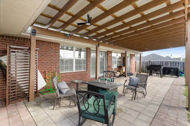 a outdoor space with lots of tables a chair and a fireplace
