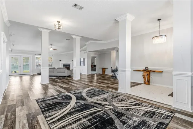 a kitchen with lots of counter top space and wooden floor