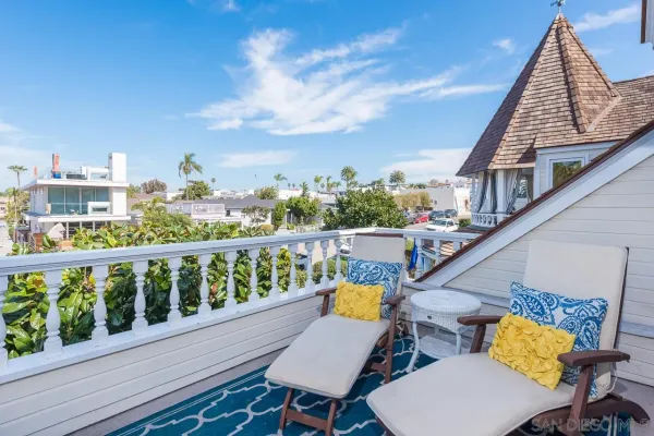 a view of a balcony with wooden chairs