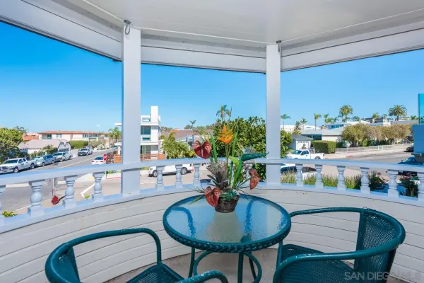 a dining room with furniture and a floor to ceiling window