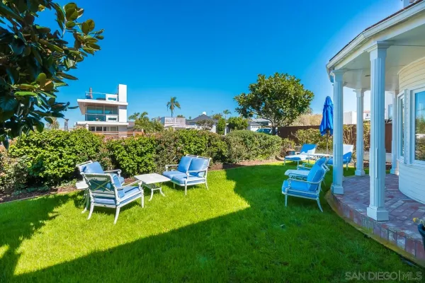 a view of a chair and table in the garden