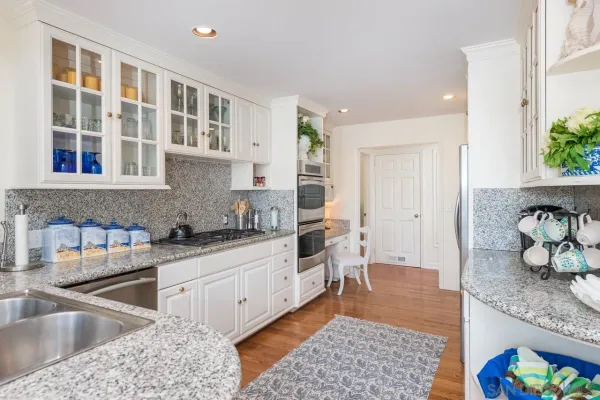 a kitchen with stainless steel appliances granite countertop a sink stove and cabinets