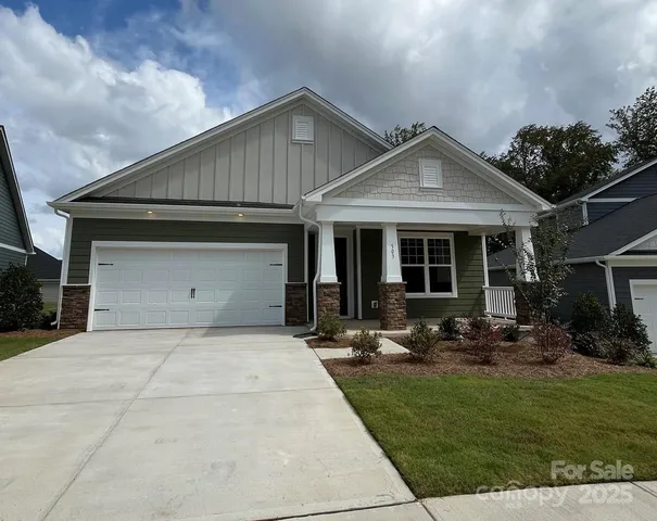 a front view of a house with sitting area and garden