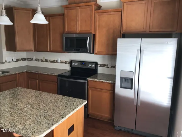 a kitchen with a sink appliances and cabinets