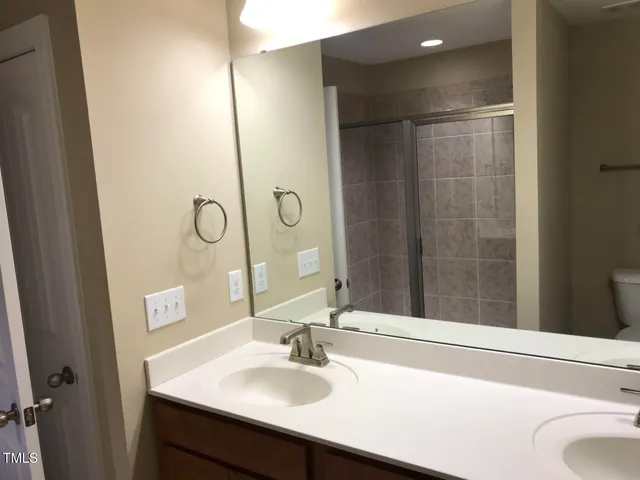 a bathroom with a shower and a sink