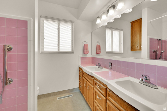2467 South 2000 West Syracuse, UT 84075 - Photo 9 of 28 Bathroom featuring a dual vanity with oak cabinetry and integrated sinks