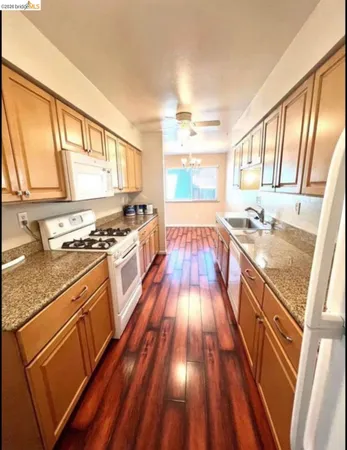 a kitchen with wooden floors and a stove