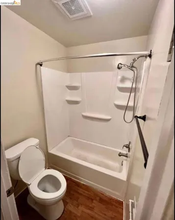 a bathroom with a sink a toilet and a shower